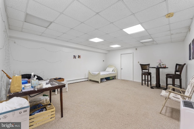 bedroom featuring carpet, a baseboard heating unit, and a paneled ceiling