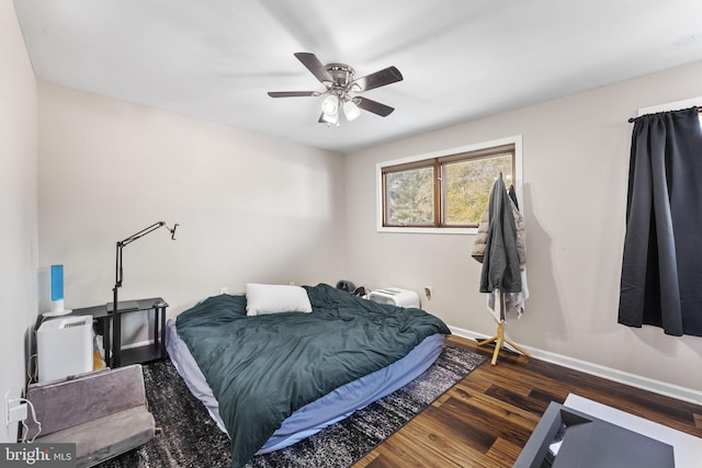 bedroom featuring dark hardwood / wood-style floors and ceiling fan