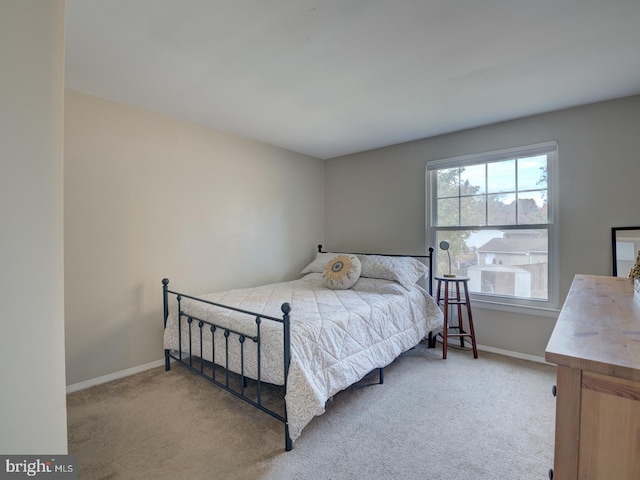 carpeted bedroom with baseboards
