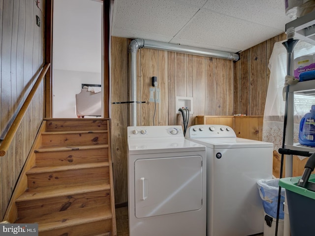 9321 Linhurst Dr, Clinton, MD 20735 - laundry area with wooden walls and washing machine and clothes dryer