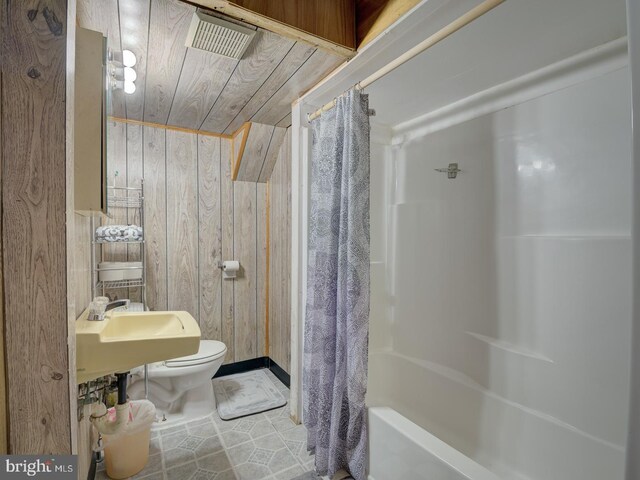 9321 Linhurst Dr, Clinton, MD 20735 - bathroom featuring wooden walls, toilet, and tile patterned flooring