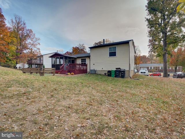 9321 Linhurst Dr, Clinton, MD 20735 - back of house featuring a wooden deck, a lawn, and central air condition unit