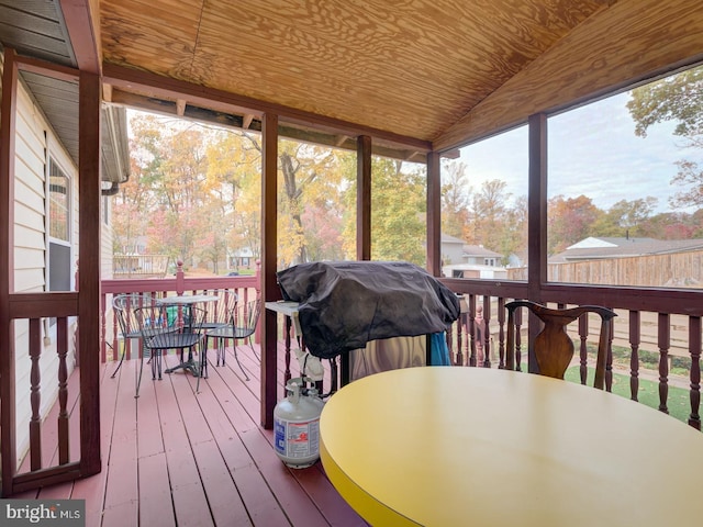 sunroom with a healthy amount of sunlight and outdoor dining space