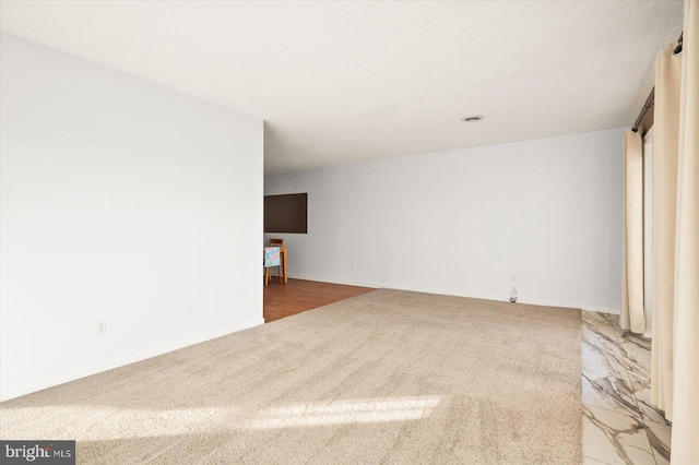 spare room featuring wood-type flooring