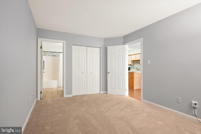 unfurnished bedroom featuring a textured ceiling and carpet