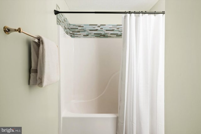 bathroom featuring shower / bathtub combination with curtain