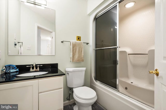 full bathroom featuring vanity, bath / shower combo with glass door, and toilet