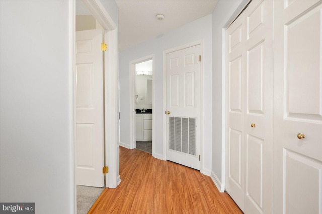 hallway with light hardwood / wood-style flooring