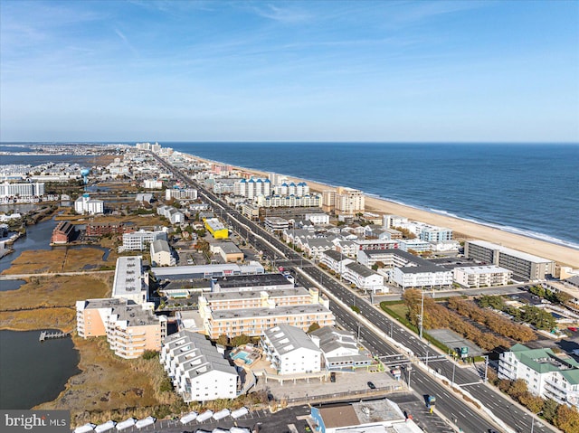 drone / aerial view with a water view and a beach view