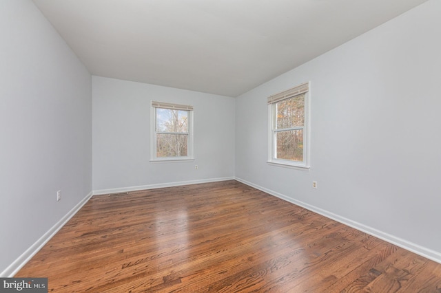 spare room with wood-type flooring