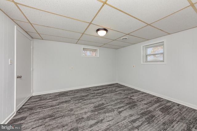 basement featuring a drop ceiling and a healthy amount of sunlight