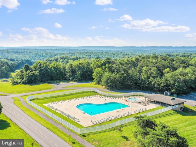 view of swimming pool with a yard, a patio area, and a community hot tub