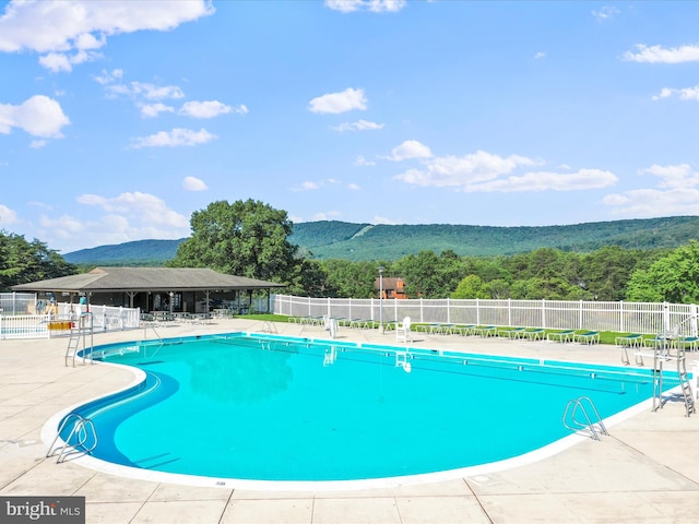 view of pool with a mountain view and a patio area