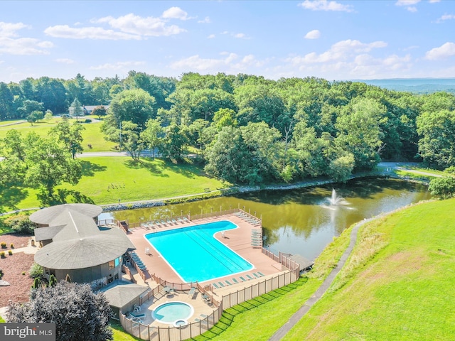 view of pool with a patio, an in ground hot tub, a water view, and a lawn