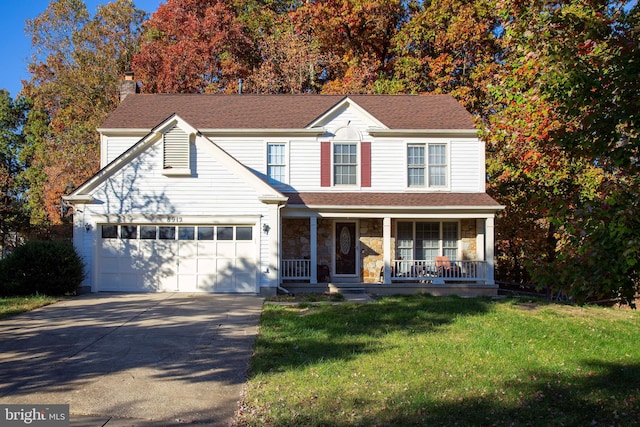 view of front of home featuring a front lawn, a garage, and a porch