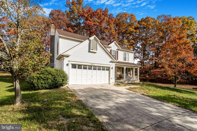 view of property with a garage and a front yard