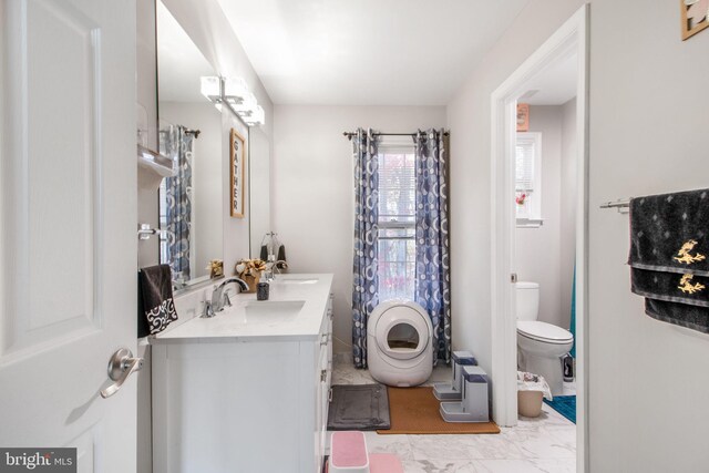 bathroom featuring vanity and toilet