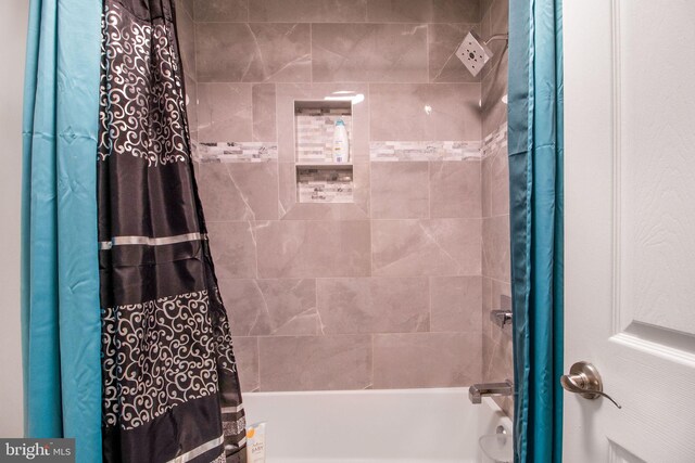 bathroom with shower / bath combo with shower curtain