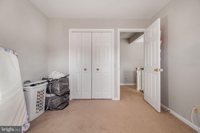 carpeted bedroom with a closet