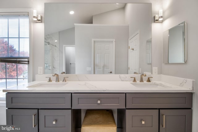 bathroom with walk in shower, lofted ceiling, and vanity