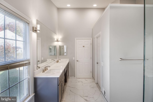 bathroom with a high ceiling and vanity