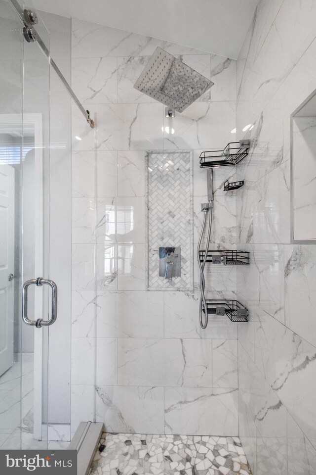 bathroom featuring a shower with door