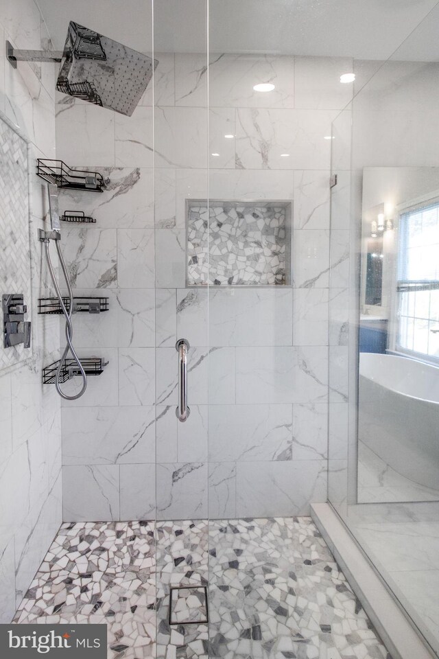 bathroom featuring a shower with shower door