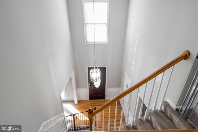 foyer featuring hardwood / wood-style floors and a notable chandelier