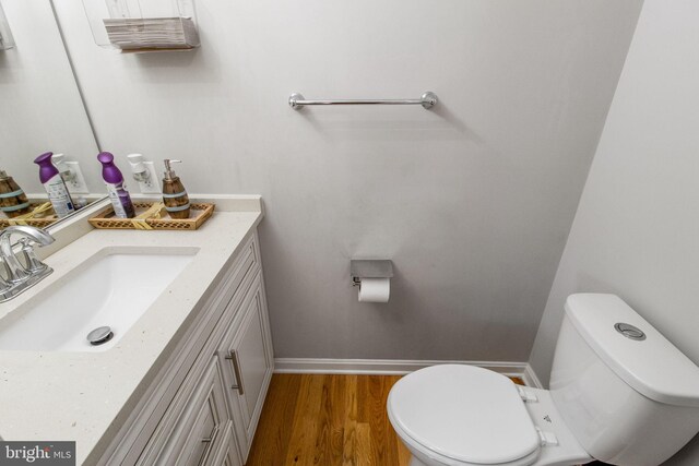 bathroom featuring hardwood / wood-style floors, vanity, and toilet