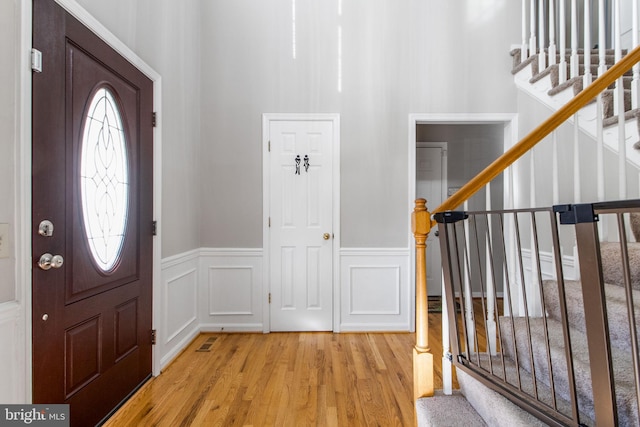 entrance foyer featuring light hardwood / wood-style floors and a healthy amount of sunlight