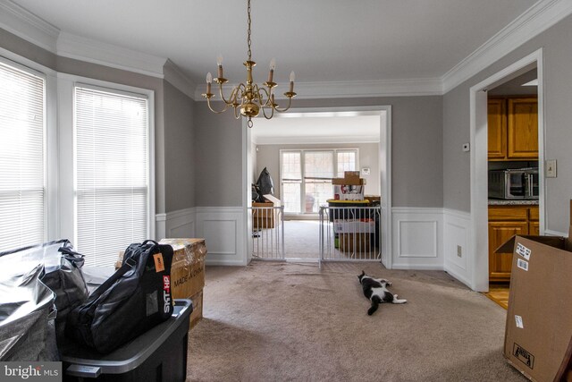 interior space with a chandelier and crown molding