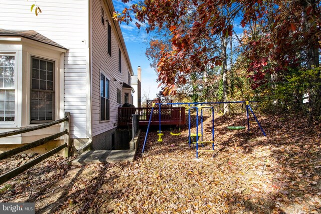 view of yard with a playground and a wooden deck