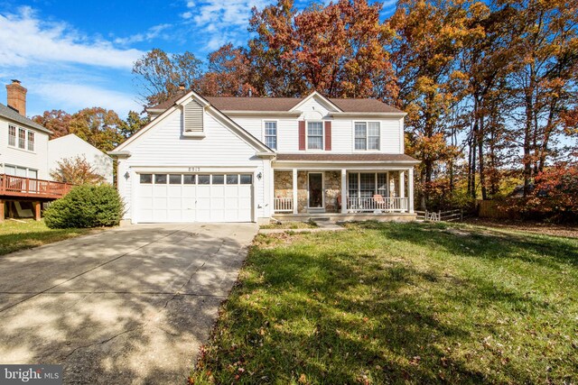 front of property featuring a garage, a porch, and a front lawn