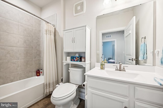 full bathroom featuring toilet, vanity, wood-type flooring, and shower / bathtub combination with curtain