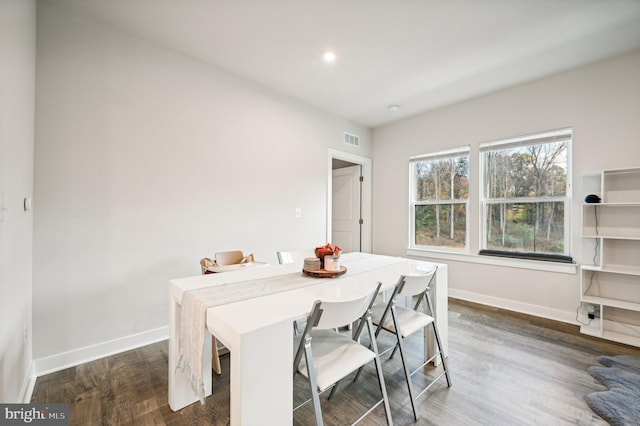 dining space with dark hardwood / wood-style floors