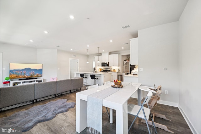 dining area with dark wood-type flooring