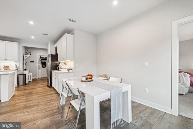 dining space with light hardwood / wood-style flooring