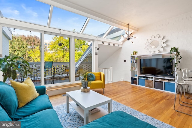 living room featuring an inviting chandelier and hardwood / wood-style floors