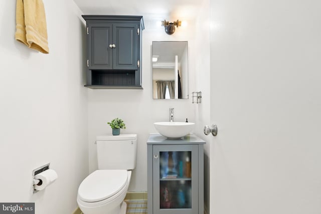 bathroom with vanity, toilet, and tile patterned flooring