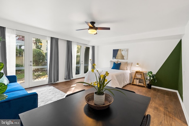 bedroom with french doors, ceiling fan, access to outside, and dark hardwood / wood-style flooring