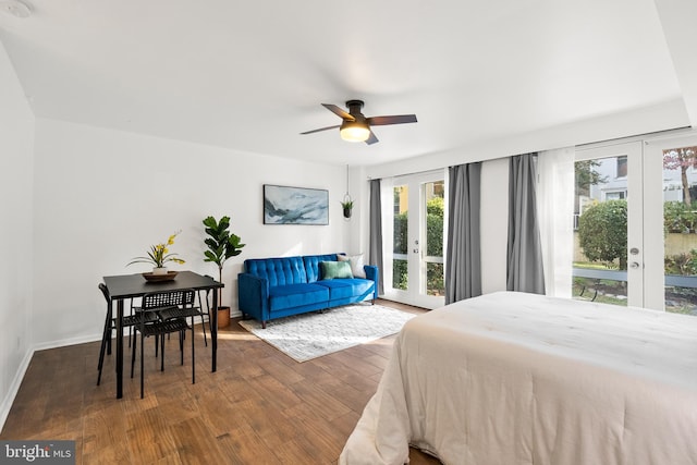 bedroom featuring access to outside, multiple windows, and dark hardwood / wood-style flooring