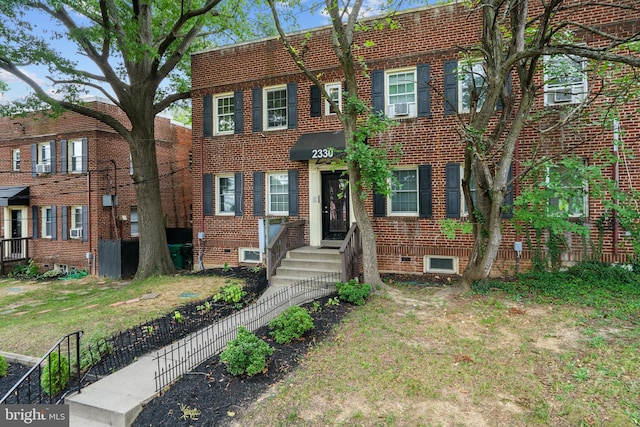 view of property with cooling unit and a front yard