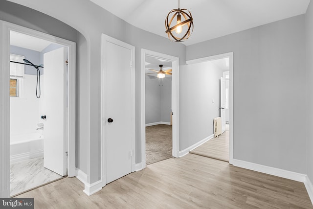 hall with light hardwood / wood-style floors and radiator