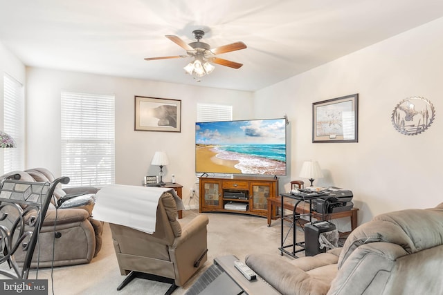 living room featuring light colored carpet and ceiling fan