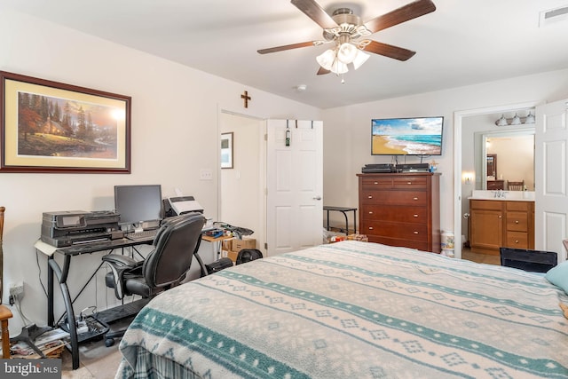 bedroom featuring ensuite bath, ceiling fan, and sink