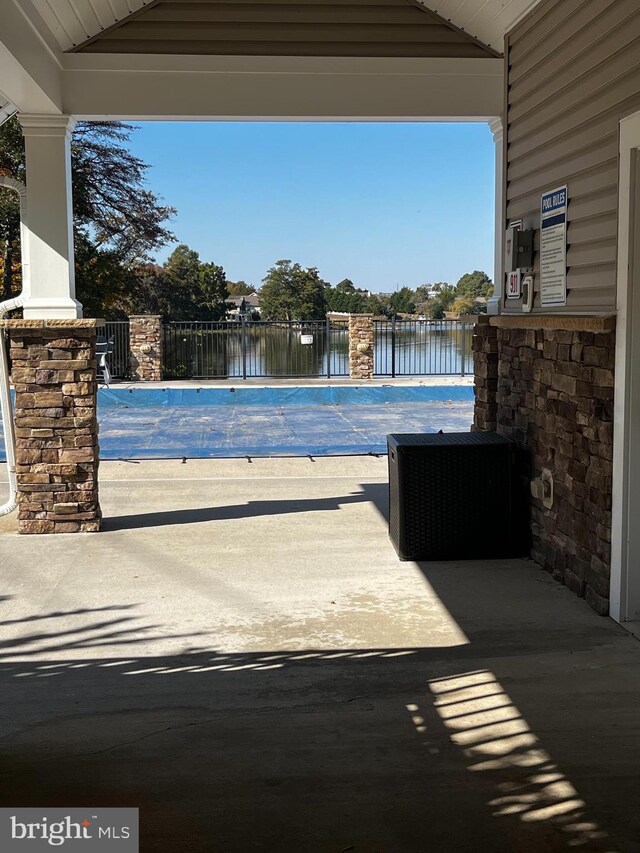 view of pool with a water view