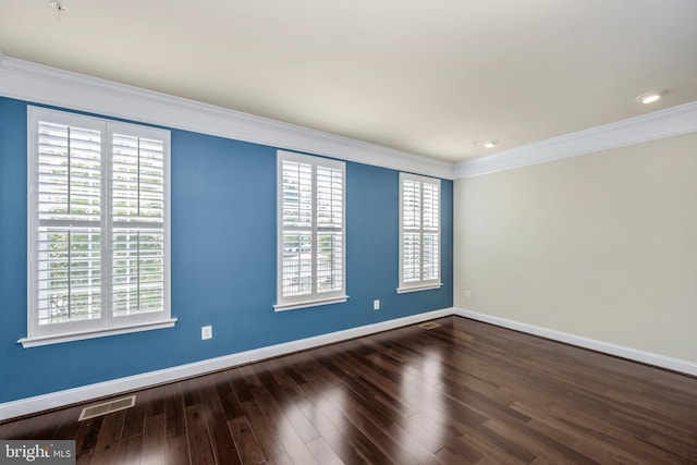 unfurnished room featuring dark wood-type flooring and crown molding