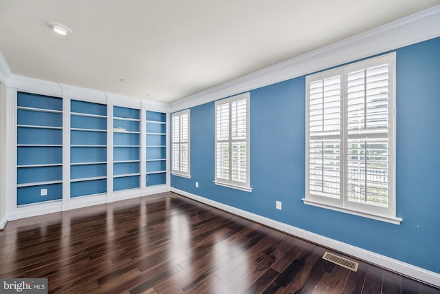 spare room featuring ornamental molding, hardwood / wood-style floors, and a healthy amount of sunlight