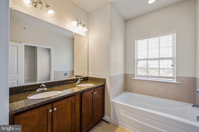 bathroom with vanity, tile patterned flooring, and a bathing tub