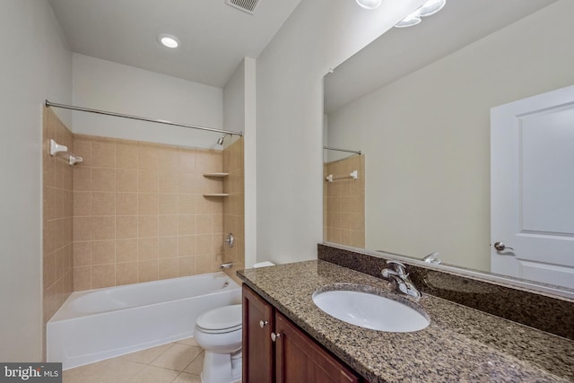 full bathroom with tiled shower / bath, vanity, toilet, and tile patterned flooring